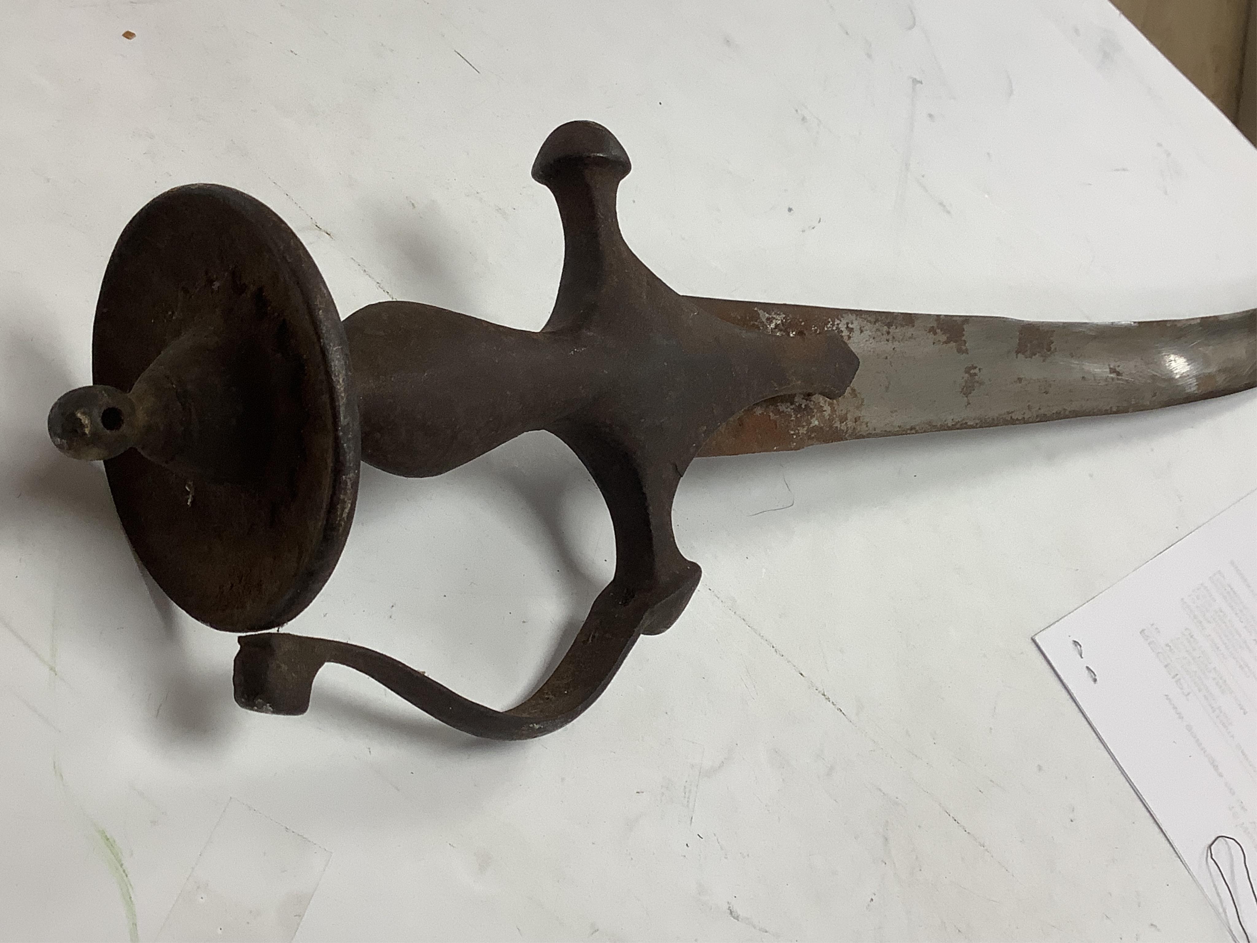 An Indian Tulwar sword, in scabbard and two small kukri, largest 93cm long.